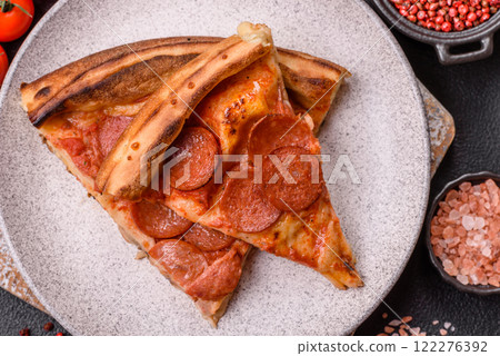 Pepperoni pizza with sausage, mozzarella cheese, tomatoes, salt and spices Pepperoni pizza with sausage, mozzarella cheese, tomatoes, salt and spices 122276392