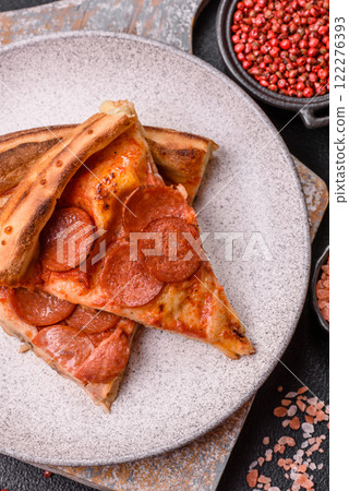 Pepperoni pizza with sausage, mozzarella cheese, tomatoes, salt and spices 122276393