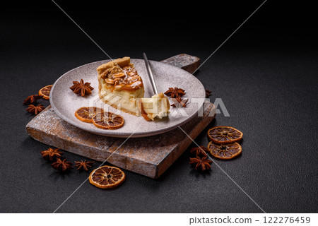 Delicious fresh cheesecake caramel peanut cake with cream and nuts on a ceramic plate on a dark concrete background Delicious fresh cheesecake caramel peanut cake with cream and nuts on a ceramic plate on a dark concrete background 122276459