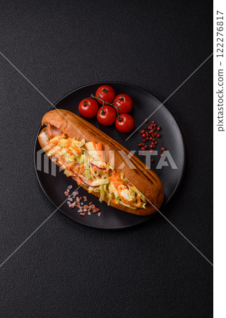 Hotdog with grilled sausage with cabbage, carrots and onions Hotdog with grilled sausage with cabbage, carrots and onions 122276817
