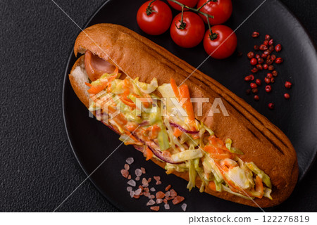 Hotdog with grilled sausage with cabbage, carrots and onions 122276819