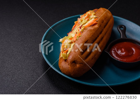 Hotdog with grilled sausage with cabbage, carrots and onions Hotdog with grilled sausage with cabbage, carrots and onions 122276830