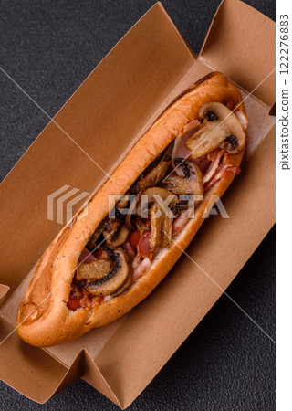 Hotdog with grilled sausage with bacon and mushrooms 122276883