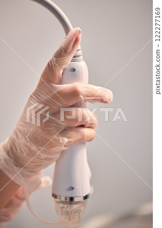 A man is currently undergoing a specialized facial treatment within a serene spa setting 122277169