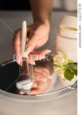 An Elegant Spa Setup Featuring a Beautiful Bowl, Fresh Flowers, and Essential Skincare Tools 122277178