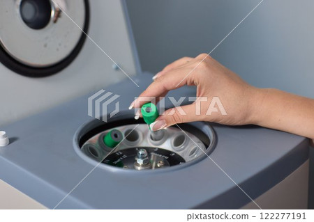 A Laboratory Centrifuge equipped with Blood Sample Tubes for scientific testing and analysis 122277191