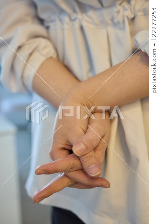 Hands Intertwined in a Relaxed Gesture, Reflecting a Deep Sense of Connection and Calmness 122277253