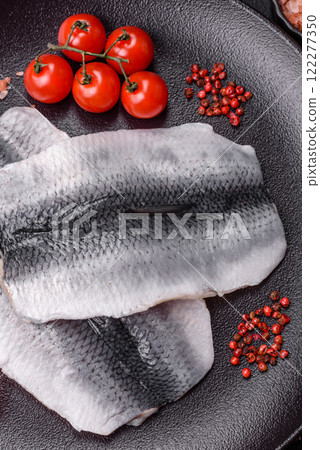 Herring fillet salted and marinated with salt, spices and oil 122277350