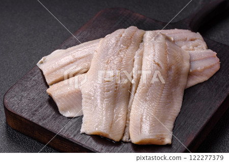 Herring fillet salted and marinated with salt, spices and oil Herring fillet salted and marinated with salt, spices and oil 122277379