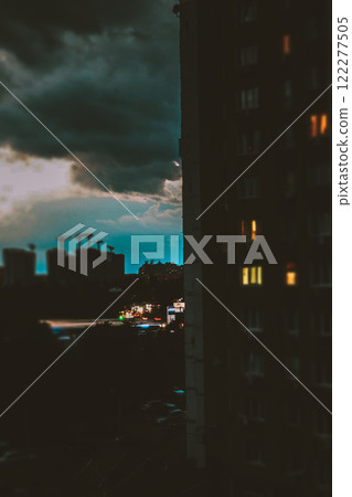 Silhouettes of high-rise buildings, construction cranes against a cloudy evening sky. Building site. Urban engineering, development and housing. Silhouettes of high-rise buildings, construction cranes against a cloudy evening sky. Building site. Urban engineering, development and housing. 122277505