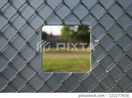 A wire fence with holes in it, a security vulnerability A wire fence with holes in it, a security vulnerability 122277638