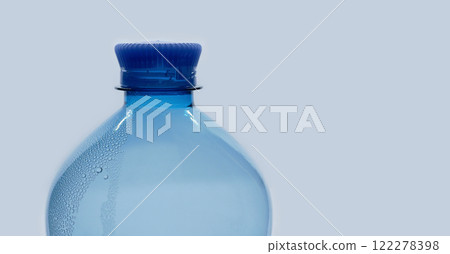 A blue plastic PET water bottle close up isolated on white background with bubble condensation on the surface. Recycling, environment friendly and ecology concept 122278398
