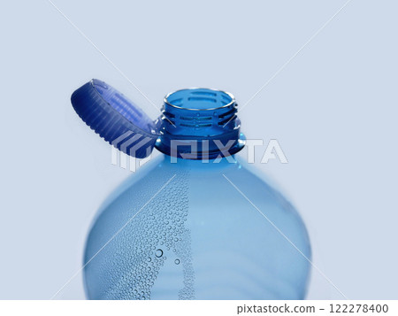 A new mechanism of plastic bottle with a stationary fixed tethered cap. Blue plastic PET water bottle with cup open close up isolated on white. Recycling, environment friendly and ecology concept A new mechanism of plastic bottle with a stationary fixed tethered cap. Blue plastic PET water bottle with cup open close up isolated on white. Recycling, environment friendly and ecology concept 122278400