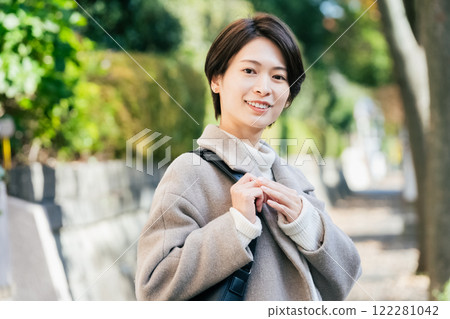 A woman walking outdoors 122281042