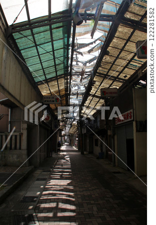 A dilapidated shopping street with shuttered shops 122281582