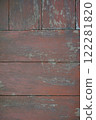 An old red wooden floor with dirt stains serves as a background. 122281820