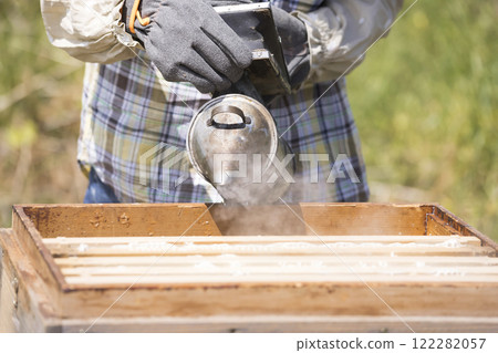 Beekeeping image: Woman using a smoker 122282057