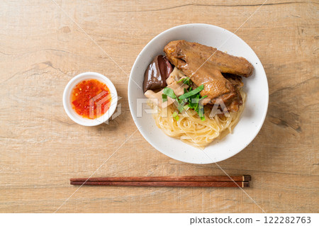 dried noodles with braised duck in white bowl 122282763