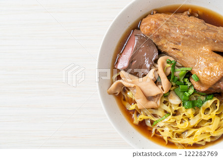 egg noodles with stewed and braised duck in brown soup 122282769