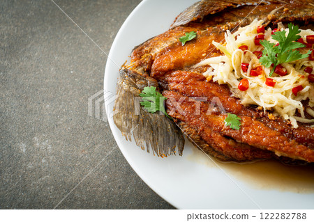 Fried Sea Bass Fish with Fish Sauce and Spicy Salad 122282788