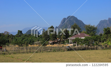 Phapoak Mountain and farmland in Vang Vieng, Laos. Phapoak Mountain and farmland in Vang Vieng, Laos. 122284595