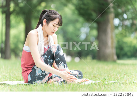 Young woman suffering from ankle injury/sprain (yoga/exercise) 122285842