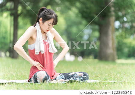Young woman suffering from pelvic pain (yoga, exercise) Young woman suffering from pelvic pain (yoga, exercise) 122285848
