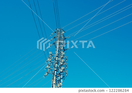 A power transmission tower towering in a clear blue sky a-3 Emphasis on warm and cool colors A power transmission tower towering in a clear blue sky a-3 Emphasis on warm and cool colors 122286284