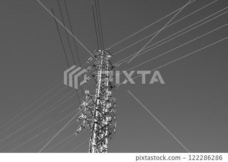 A power transmission tower towering in a clear blue sky a-5 monochrome A power transmission tower towering in a clear blue sky a-5 monochrome 122286286