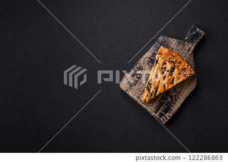 Pieces of quiche with salmon, spinach or broccoli, salt and spices Pieces of quiche with salmon, spinach or broccoli, salt and spices 122286863