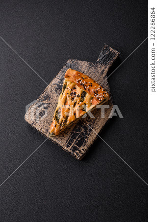 Pieces of quiche with salmon, spinach or broccoli, salt and spices 122286864