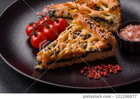 Pieces of quiche with salmon, spinach or broccoli, salt and spices Pieces of quiche with salmon, spinach or broccoli, salt and spices 122286877