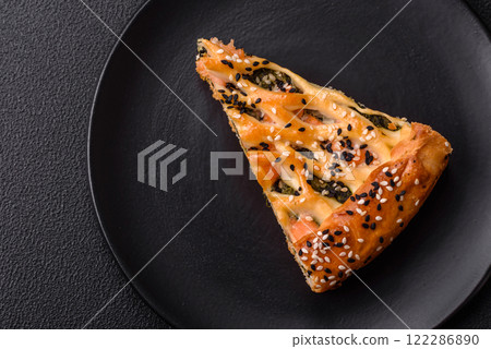 Pieces of quiche with salmon, spinach or broccoli, salt and spices Pieces of quiche with salmon, spinach or broccoli, salt and spices 122286890