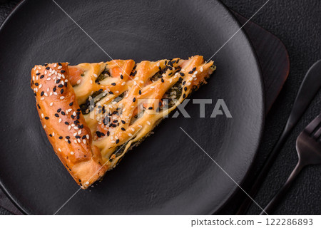 Pieces of quiche with salmon, spinach or broccoli, salt and spices 122286893