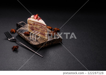 Piece of sweet layer cake with white cream, raspberries and strawberries 122287128