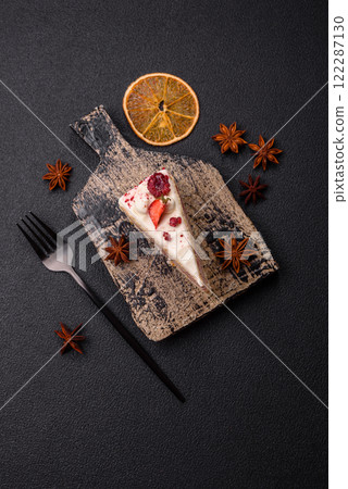 Piece of sweet layer cake with white cream, raspberries and strawberries 122287130