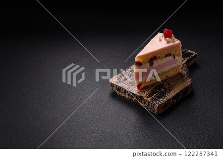 Piece of sweet cake with pink cream with raspberry flavor, with shortbread, cheesecake 122287341
