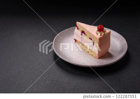 Piece of sweet cake with pink cream with raspberry flavor, with shortbread, cheesecake 122287351