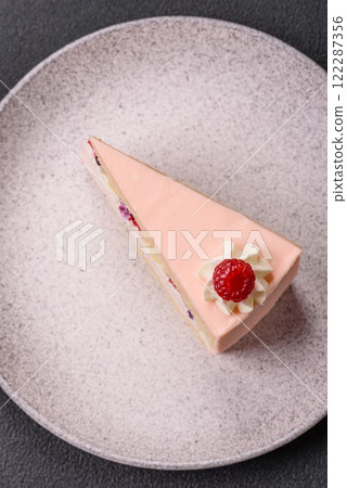 Piece of sweet cake with pink cream with raspberry flavor, with shortbread, cheesecake Piece of sweet cake with pink cream with raspberry flavor, with shortbread, cheesecake 122287356