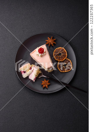 Piece of sweet cake with pink cream with raspberry flavor, with shortbread, cheesecake 122287365