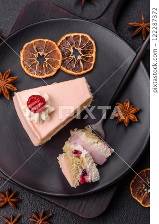 Piece of sweet cake with pink cream with raspberry flavor, with shortbread, cheesecake 122287372