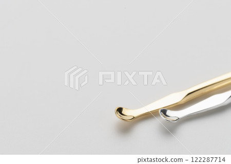 Earpick, gold and silver, ear cleaning tool, white background Earpick, gold and silver, ear cleaning tool, white background 122287714