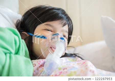 Sick little asian girl inhalation with nebulizer for respiratory treatment Sick little asian girl inhalation with nebulizer for respiratory treatment 122287953