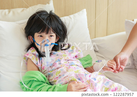 Sick little asian girl inhalation with nebulizer for respiratory treatment 122287957