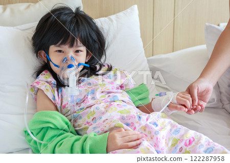 Sick little asian girl inhalation with nebulizer for respiratory treatment 122287958