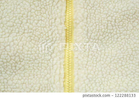Yellow zipper on wool plush fleece fur fabric texture background 122288133