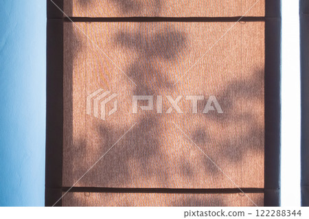 Abstract tree leaves shadow drop on brown curtain window background Abstract tree leaves shadow drop on brown curtain window background 122288344