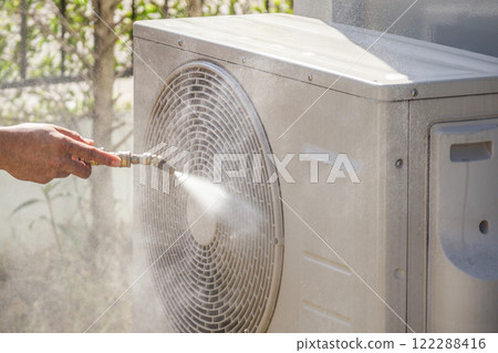 air conditioning compressor outdoor unit cleaning service with water spray 122288416
