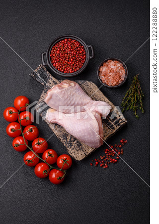 Raw chicken legs with salt, spices, herbs and tomatoes Raw chicken legs with salt, spices, herbs and tomatoes 122288880