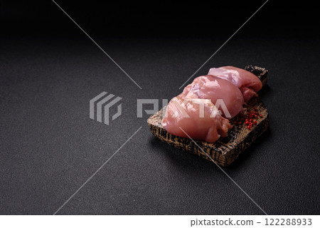 Fresh raw chicken thigh fillets with salt, spices and herbs Fresh raw chicken thigh fillets with salt, spices and herbs 122288933